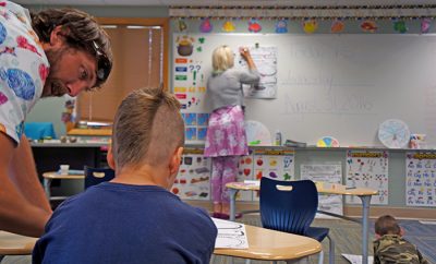 Yellowstone Academy staff work with students in the remodeled classroom on the first day of school.